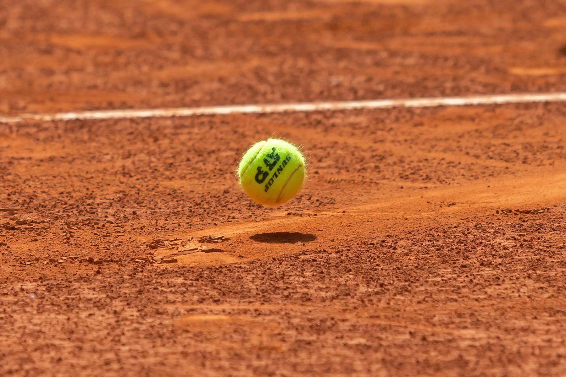 Tennis ball bouncing on the red clay court at the ATP Madrid Open