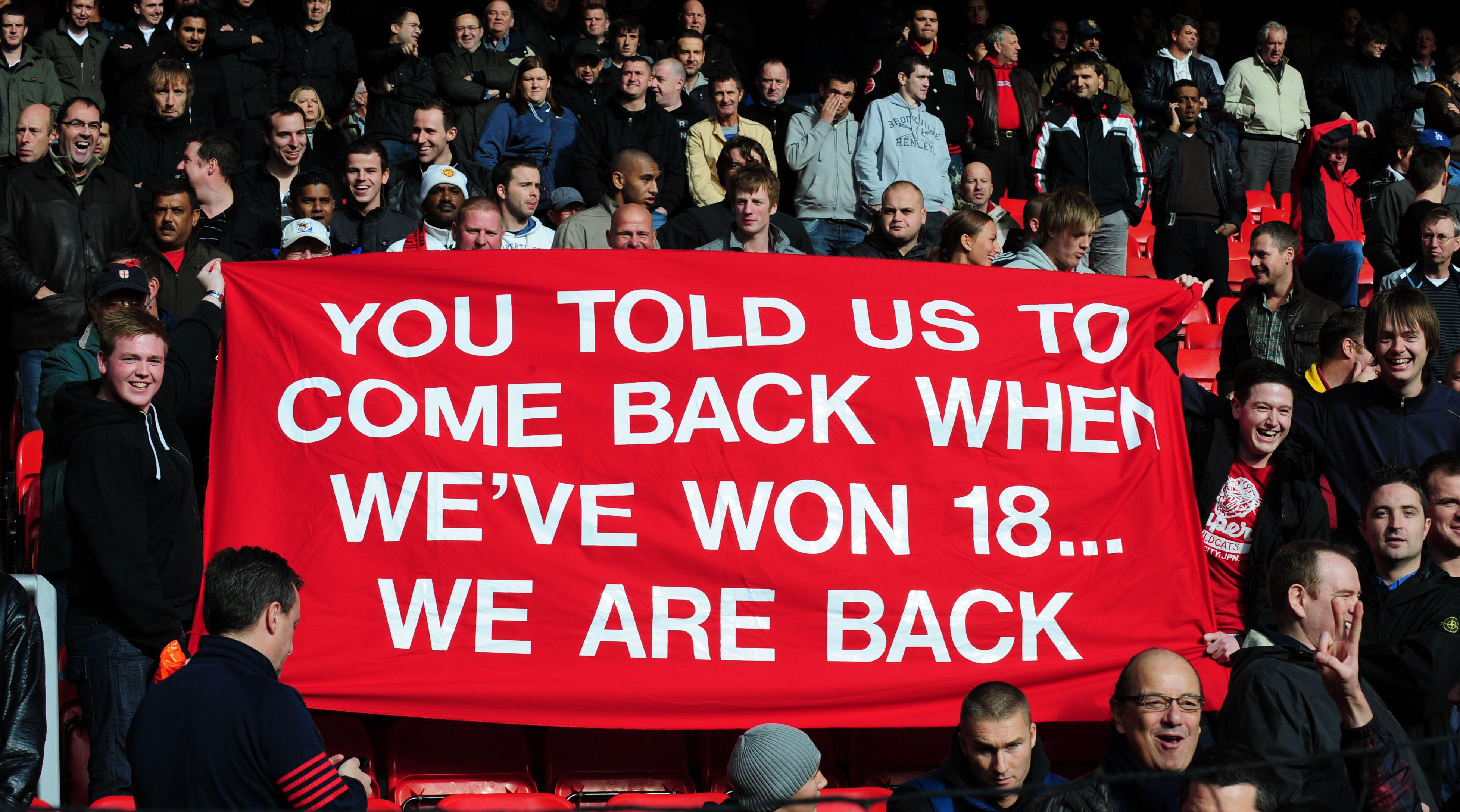 Manchester United fans taunt Liverpool fans at Anfield in October 2009. Photo: Sportimage / Alamy Stock Photo
